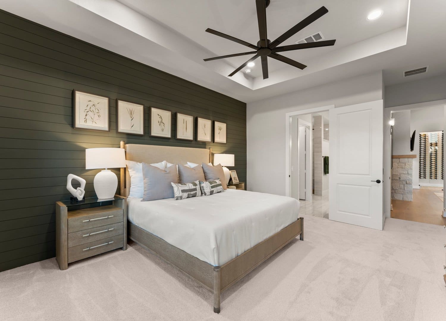 Primary suite with dark green feature wall in the Teramo model
